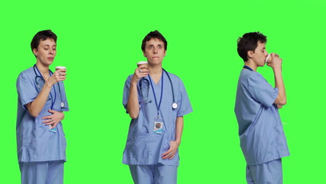 Healthcare-specialist-enjoying-hot-coffee-cup-against-greenscreen-backdrop